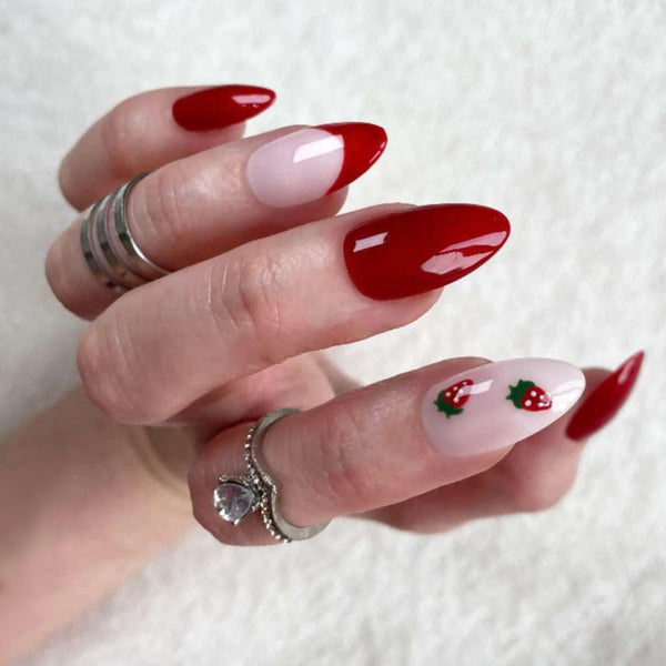 Load image into Gallery viewer, A hand wearing press-on nails with a strawberry design, in deep red and soft pink, with a French tip on one nail, against a soft white background.