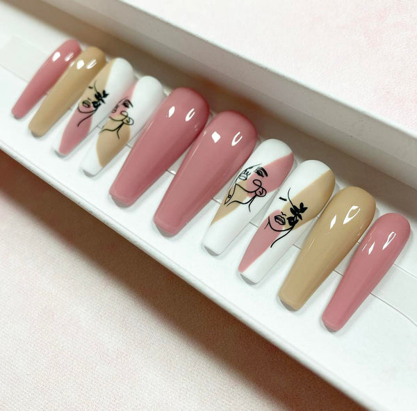 Load image into Gallery viewer, Pink and beige handmade false nails with abstract female faces design, in pastel beige and blush pink, from Illuminate by Liana
