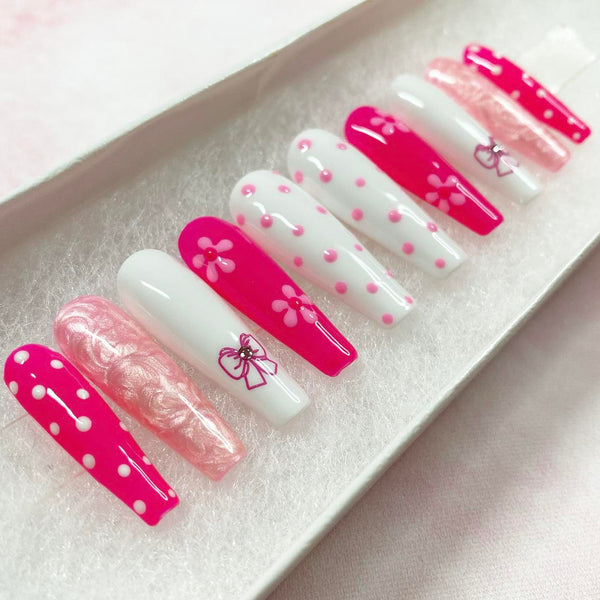 Load image into Gallery viewer, Coquette design press on nails in various shades of pink and white, with pink shimmery marble effect, floral and bows artwork.