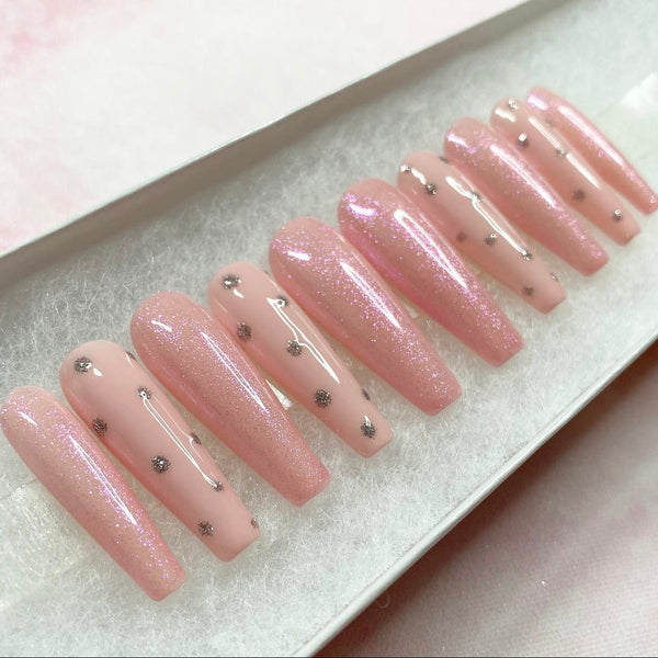 Load image into Gallery viewer, Long coffin glittery pink handmade false nails with small decorative silver elements, in a white presentation box.