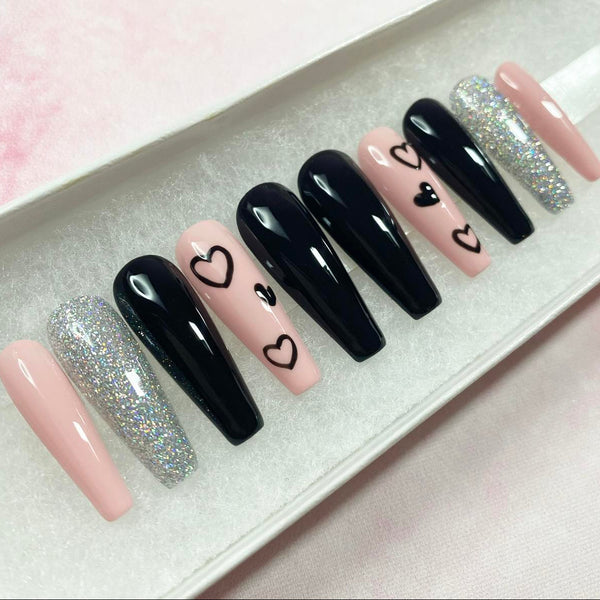 Load image into Gallery viewer, Long coffin handmade press-on nails in pink, black and silver, with a heart design and silver glitter, in a white presentation box.