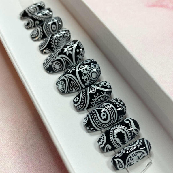 Load image into Gallery viewer, Short handmade false nails with a black and white paisley bandana design, in a white presentation box.