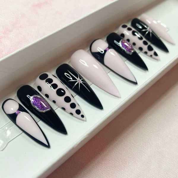 Load image into Gallery viewer, Black, purple and pink handmade false nails with silver chrome stars and purple glitter accents, in a long stiletto shape.