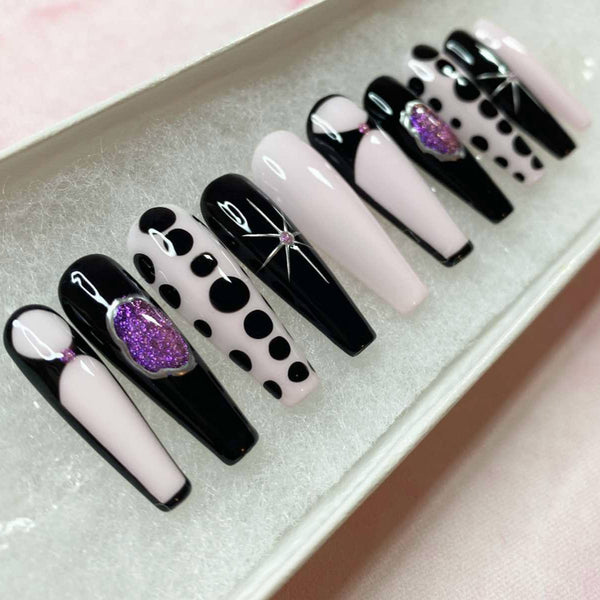 Load image into Gallery viewer, Handmade press-on nails in black, pale pink, and silver colors with purple glitter and star patterns, with a gothic vibe, in a white presentation box