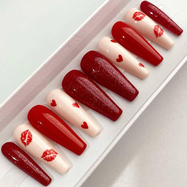 Load image into Gallery viewer, Valentine's design red and cream press-on nails with lips and hearts designs and red glitter, handmade by Illuminate by Liana