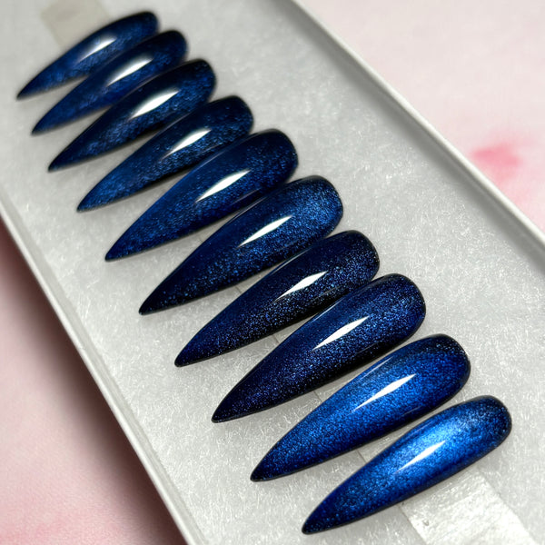 Load image into Gallery viewer, Cat-eye press-on nails in dark blue-black, with a gothic witchy vibe, handmade in a long stiletto shape displayed in a white presentation box