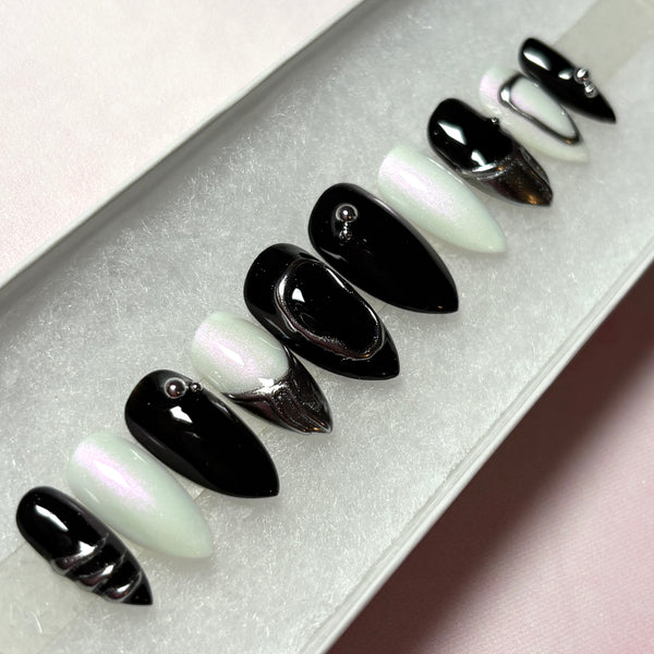 Load image into Gallery viewer, Black, white and silver chrome short stiletto press-on nails, with 3D silver chrome metallic tips on some nails and silver chrome design accents, in a white presentation box.