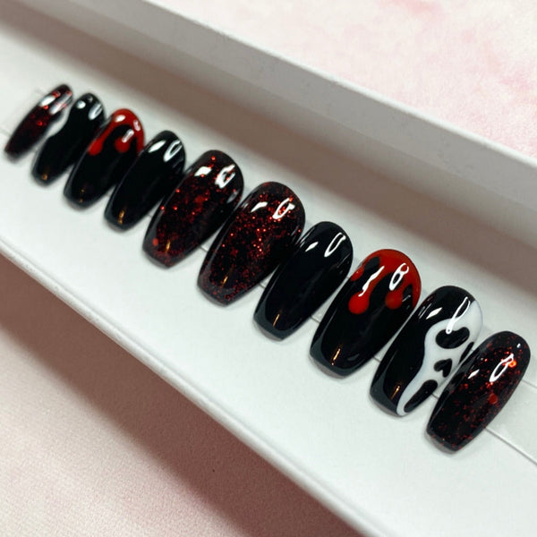 Load image into Gallery viewer, Short coffin Halloween press-on nails in black, red and white featuring red blood drip and spooky white mask designs, and subtle deep red glitter on some nails.