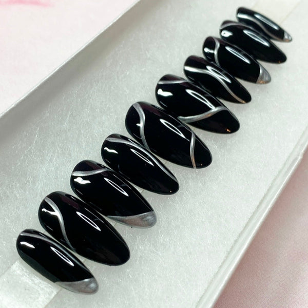 Load image into Gallery viewer, Black handmade false nails with silver chrome accents of wavy lines and alternative French tips.