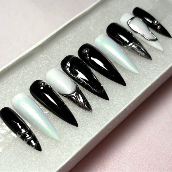 Load image into Gallery viewer, Set of black, white and silver chrome stiletto press-on nails, with 3D silver chrome metallic tips on some nails and silver chrome design accents.