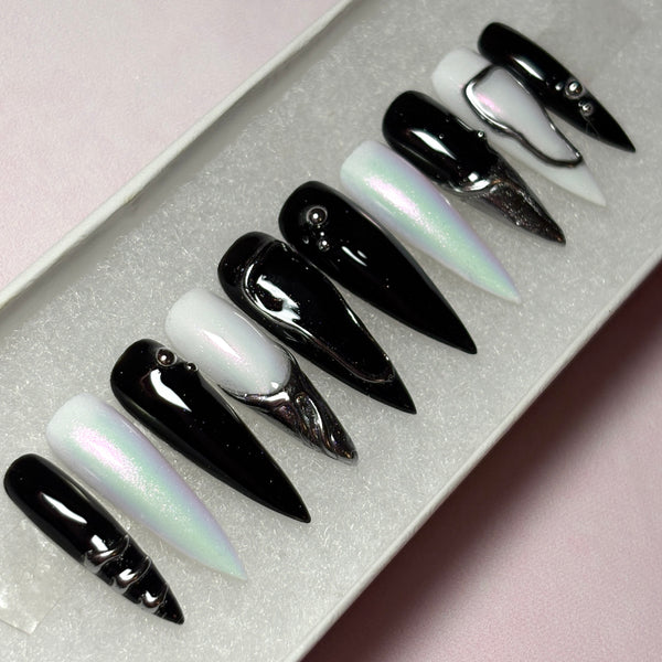 Load image into Gallery viewer, Set of black, white and silver chrome long stiletto press-on nails, with 3D silver chrome metallic tips on some nails and silver chrome design accents.
