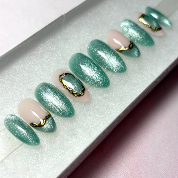 Load image into Gallery viewer, Handmade green glittery false nails with delicate gold chrome chain design accents in a white presentation box.