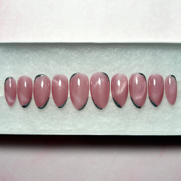 Load image into Gallery viewer, Row of shimmering pink press-on nails with silver tips in a short almond shape