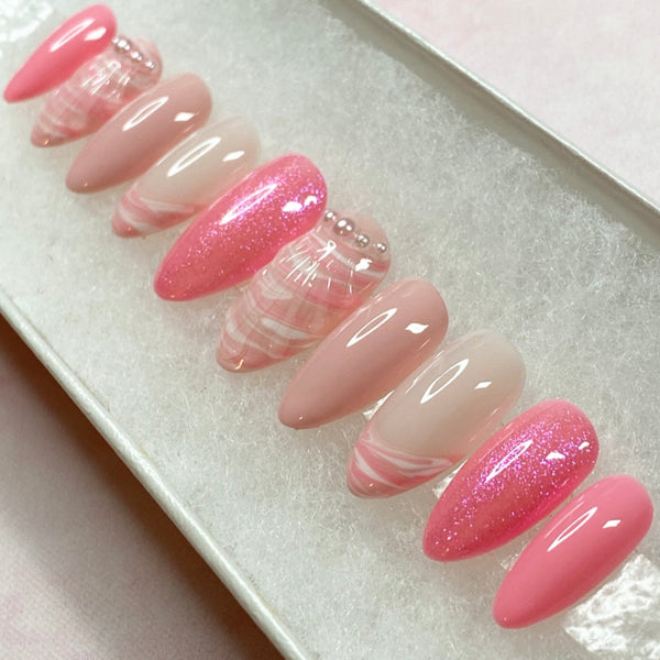 Load image into Gallery viewer, Summer press-on nails with 3D shell design, in various shades of soft and brighter pink, with a pink and white marble effect 3D shell design, French tips, tiny white pearls, and subtle pink glitter.