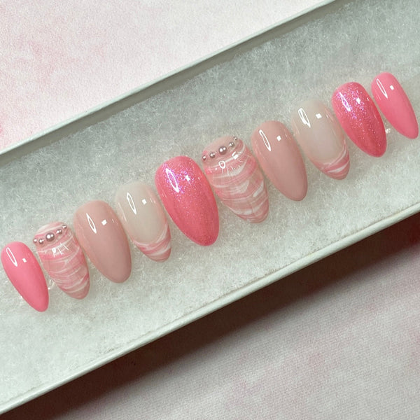 Load image into Gallery viewer, Pink summer false nails in short almond, in shades of soft and brighter pink, and white, with a 3D shell design, French tips, tiny white pearls, and subtle pink glitter.