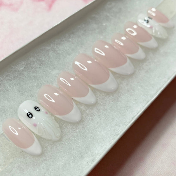 Load image into Gallery viewer, Halloween press-on nails featuring French tip nails and two cute 3D ghost accent nails, in white and soft pink, handmade by llluminate by Liana UK.