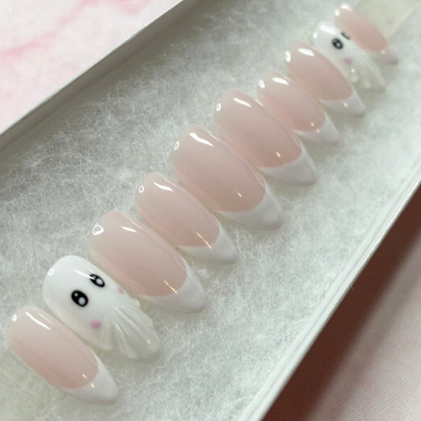 Load image into Gallery viewer, French tip Halloween press-on nails in a short almond shape, with two 3D ghost accent nails, in white and soft pink, from Illuminate by Liana UK.