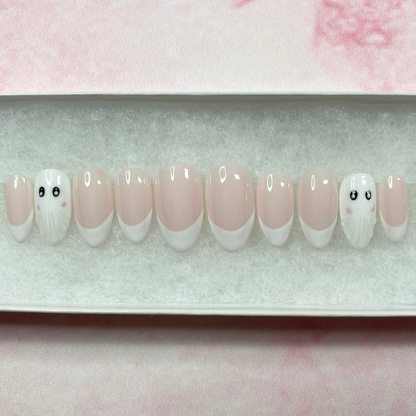Load image into Gallery viewer, French tip Halloween press-on nails in a short almond shape, with two 3D ghost accent nails, in white and soft pink, displayed in a white presentation box.