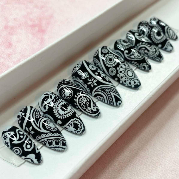 Load image into Gallery viewer, Bandana design long almond press-on nails in black and white paisley pattern, in a white presentation box.