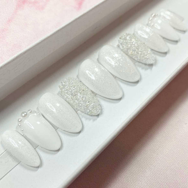 Load image into Gallery viewer, Short wedding-bridal press-on nails with tiny white caviar beads, shimmering white glitter and delicate pearl accents, in a white presentation box.