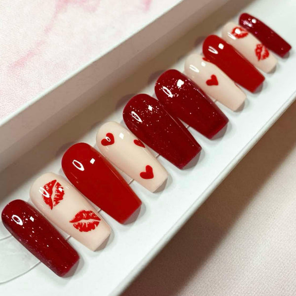 Load image into Gallery viewer, Valentine's handmade press-on nails in red and nude with red hearts and lips designs and red glitter from Illuminate by Liana