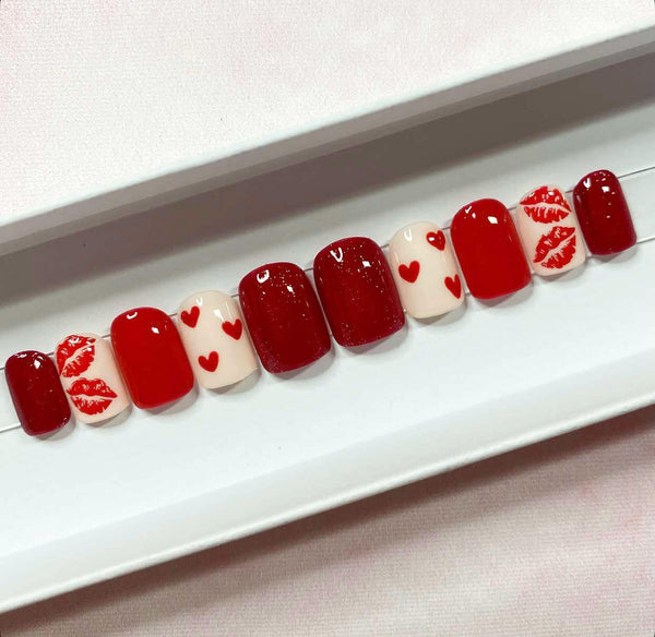 Load image into Gallery viewer, Valentine's handmade press-on nails in red and cream with lips and hearts designs and red glitter