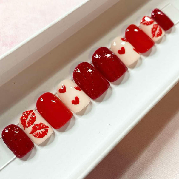 Load image into Gallery viewer, Set of Valentine's handmade red and nude press-on nails with lips and hearts designs and red glitter