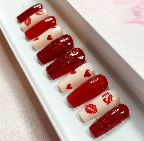 Load image into Gallery viewer, Valentine's handmade press-on nails in red and cream with red hearts and lips designs and red glitter