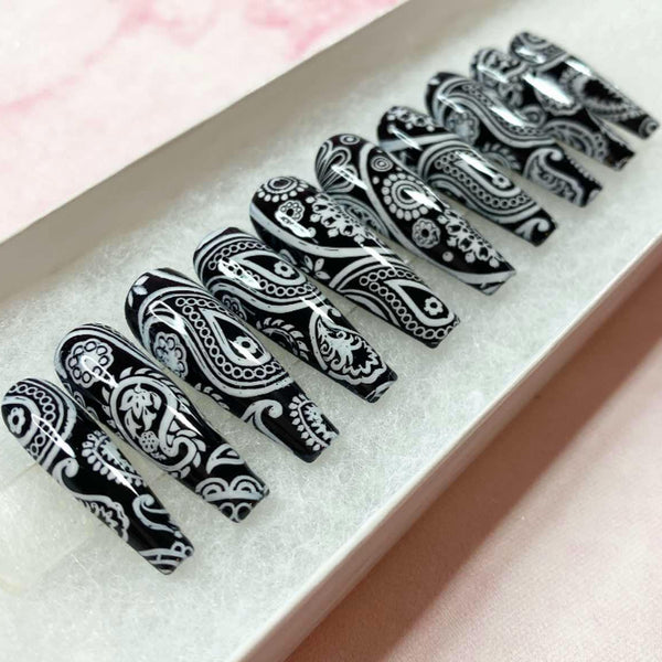 Load image into Gallery viewer, Long coffin press-on nails with a black and white paisley bandana design, in a white presentation box.