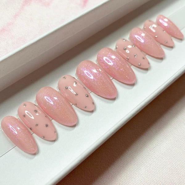 Load image into Gallery viewer, Pink press-on nails in soft pastel shades of pink with delicate silver glitter dot design and subtle pink glitter, in a white presentation box.