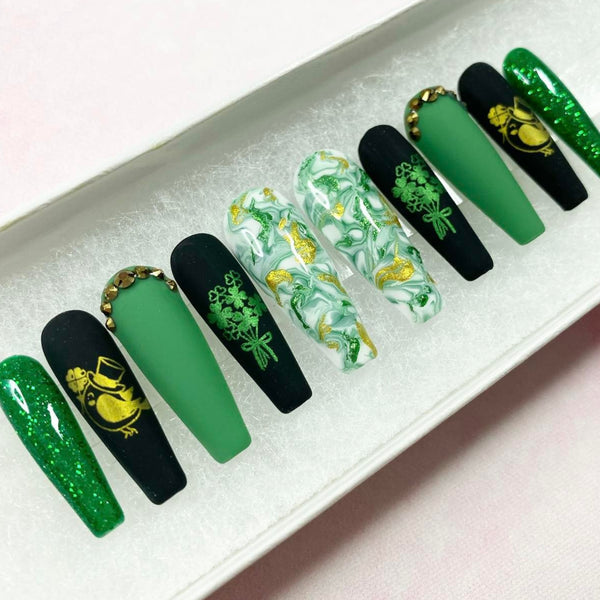 Load image into Gallery viewer, St Patrick's Day handmade false nails in green, black and gold with gold bird and green shamrocks designs, rhinestones and glitter