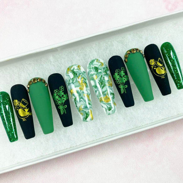 Load image into Gallery viewer, St Patrick's Day handmade false nails in green, black and gold with gold bird and green bouquet of shamrocks designs from Illuminate by Liana