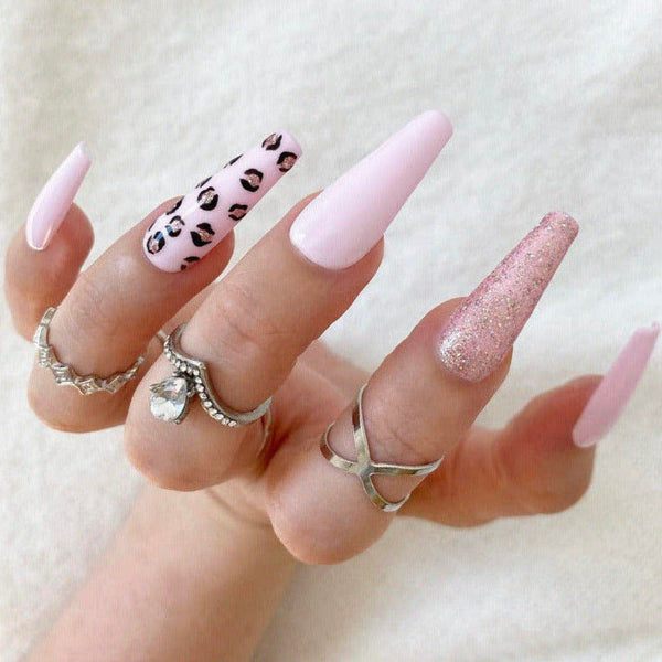 Load image into Gallery viewer, Hand wearing pink and leopard print press-on nails and silver rings on a light background