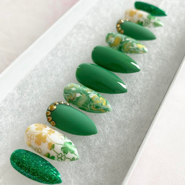 Load image into Gallery viewer, St Patrick's day press-on nails in green and gold with shamrock design and gold rhinestones, in a short stiletto shape