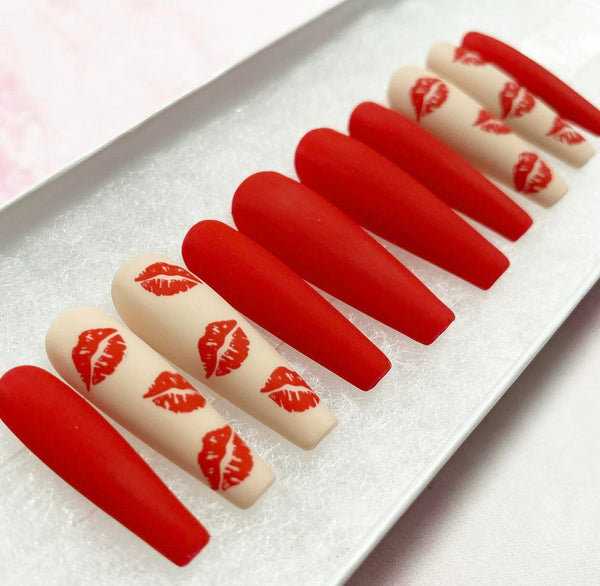 Load image into Gallery viewer, Valentine's handmade press-on nails in red and nude with a matte finish and lips designs, from Illuminate by Liana
