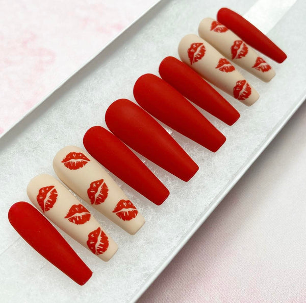 Load image into Gallery viewer, Valentine's handmade press-on nails in red and nude with a matte finish and lips designs, in a long coffin shape