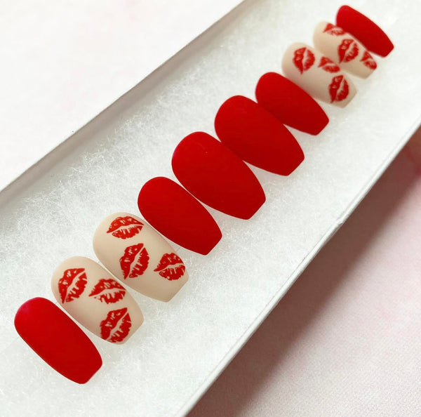 Load image into Gallery viewer, Handmade Valentine's press-on nails in red and nude with a matte finish and kiss mark designs
