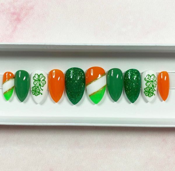 Load image into Gallery viewer, St Patrick's Day handmade press-on nails in vivid greens, orange, and gold with a lucky clover design and glitter