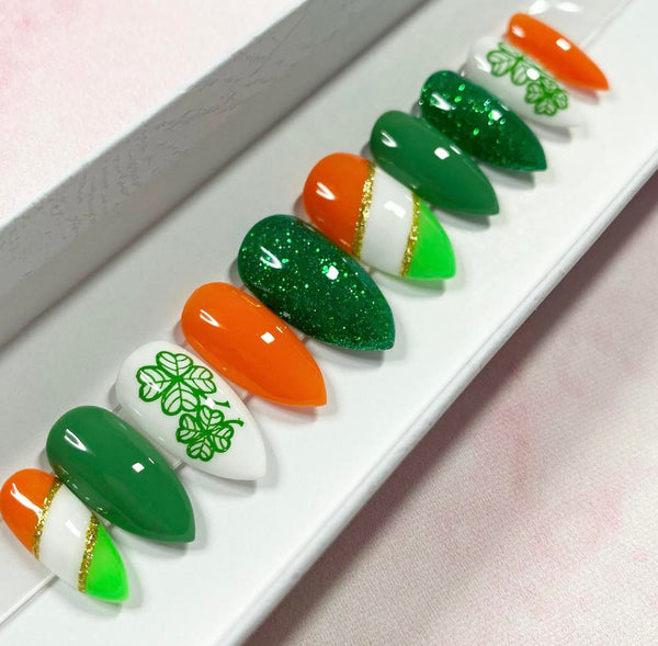 Load image into Gallery viewer, St Patrick's Day handmade false nails in green, orange, white and gold with lucky clover design and glitter, from Illuminate by Liana