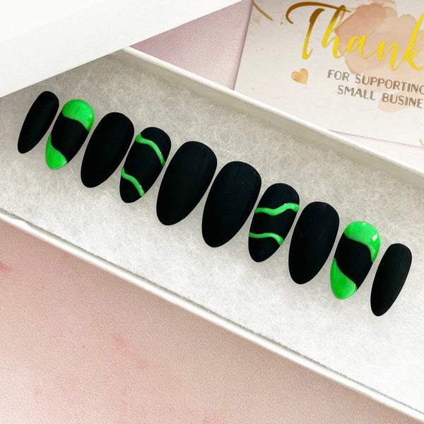 Load image into Gallery viewer, Neon green and black false featuring matte black with a neon green wavy line and abstract design on four of the nails, in a white presentation box, with a card in the background that says "Thank you for supporting my small business"