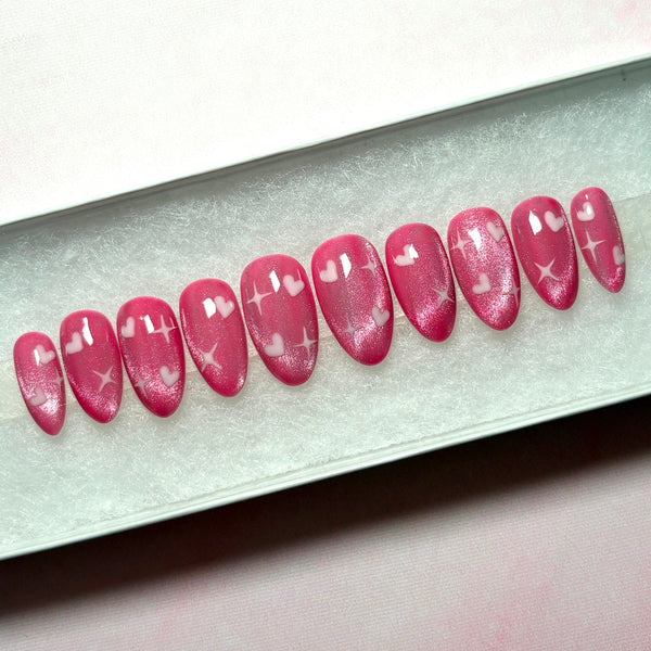 Load image into Gallery viewer, Set of pink short almond press-on nails with heart and star designs in a white presentation box.
