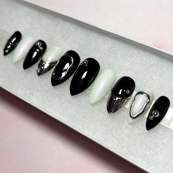 Load image into Gallery viewer, Set of black, white and silver chrome short stiletto press-on nails, with 3D silver chrome metallic tips on some nails and silver chrome design accents.
