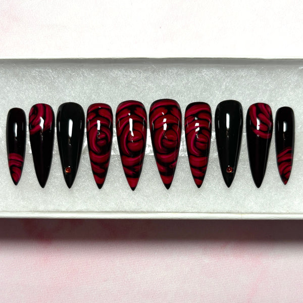 Load image into Gallery viewer, Gothic press-on nails in red and black with 3D effect deep red roses and delicate red rhinestones, in a long stiletto shape, from Illuminate by Liana UK
