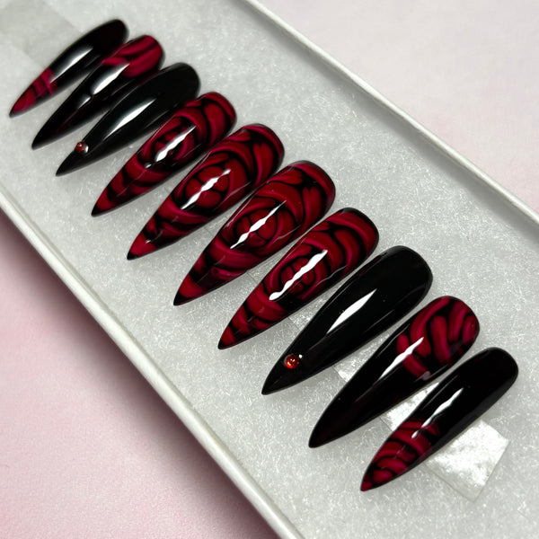 Load image into Gallery viewer, Gothic dark romance press-on nails in red and black with 3D effect deep red roses and delicate red rhinestones, in a long stiletto shape, from Illuminate by Liana UK
