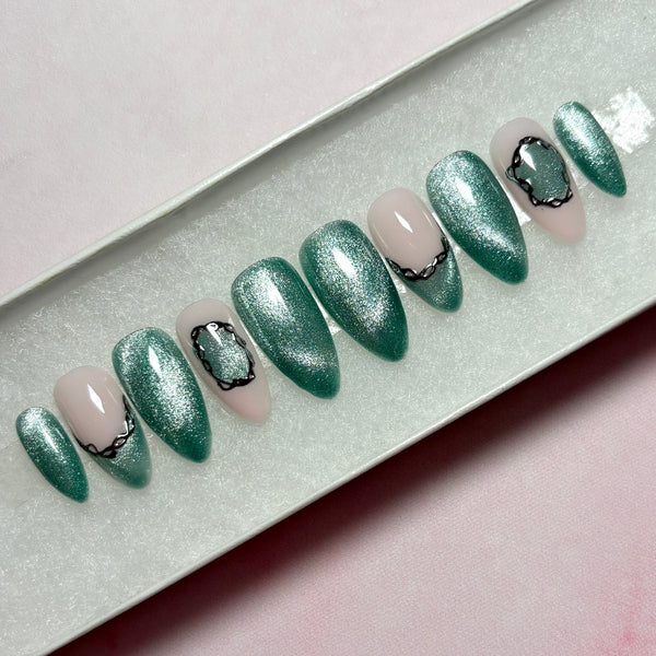 Load image into Gallery viewer, Handmade press-on nails in shimmery jade-green cat eye and pastel pink, featuring a delicate silver chrome 3D chain design on some nails, in a white presentation box.
